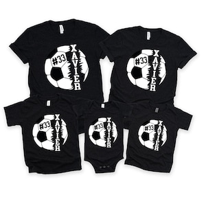 May include: Four black t-shirts featuring a white football design. The football is split in half with the word "XAVIER" written vertically on one side and the number "#33" on the other side.