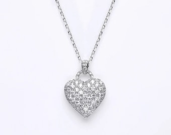 May include: A silver necklace with a heart-shaped pendant covered in small, clear cubic zirconia stones.
