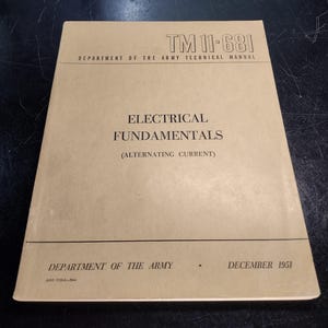May include: A brown cover of a technical manual titled "TM 11-681" for the Department of the Army. The manual is titled "Electrical Fundamentals (Alternating Current)" and was published in December 1951.