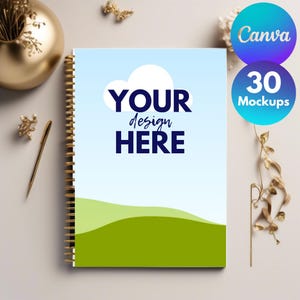 May include: A blue and green notebook mockup with a white cloud and the text "YOUR design HERE". The notebook has gold spiral binding and is on a white surface with gold decorative items.