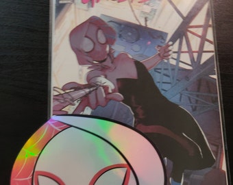 May include: A comic book featuring Spider-Gwen, also known as Ghost-Spider, in a black and white outfit with a red spider symbol on her chest. The comic book cover is illustrated in a colourful style with a pink, blue, and purple background. The comic book is titled "Spider-Gwen: Ghost-Spider" and has the number "3" on the cover.