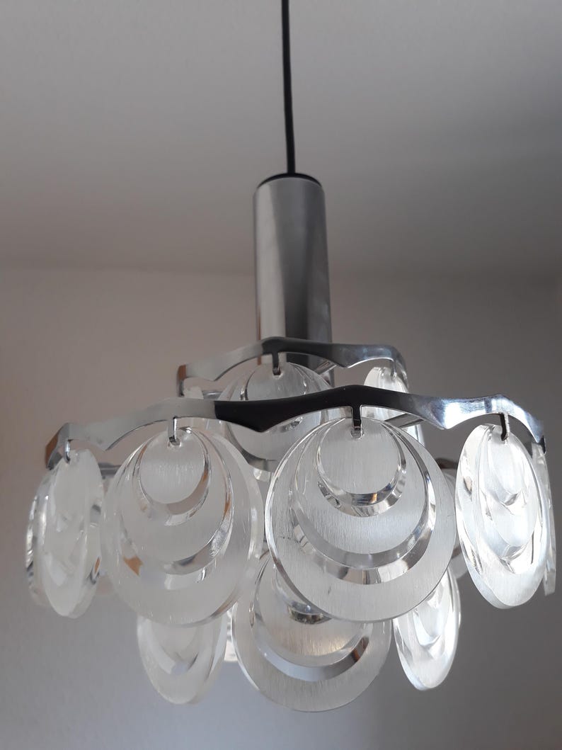 May include: A silver and clear glass pendant light fixture with multiple overlapping circular shades.