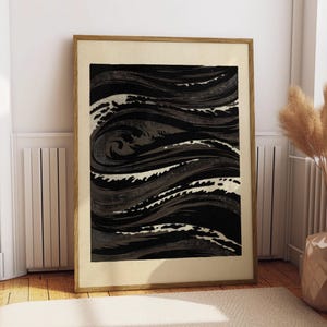 May include: A framed rectangular wall art print featuring a high-contrast abstract design of swirling, wave-like patterns in deep black, charcoal gray, and off-white tones. The artwork is encased in a simple light-toned wooden frame with a wide mat.