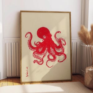 May include: A framed art print featuring a red octopus illustration on a cream-colored background. The octopus is depicted with detailed tentacles and a textured appearance. The artwork is in a wooden frame and includes Japanese text.