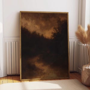 Puede incluir: Una impresión artística abstracta enmarcada con una paleta de colores oscura y melancólica. La obra de arte presenta una mezcla de tonos marrones, negros y beige, creando una sensación de profundidad y textura. La impresión se exhibe en una habitación con una alfombra neutra, suelo de madera y un jarrón con plantas secas.