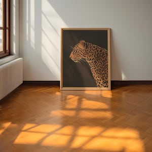 May include: A framed print of a leopard with a dark brown background. The leopard is facing to the left and has a spotted coat.
