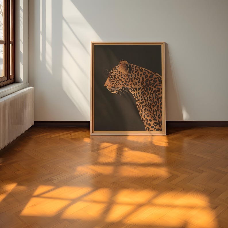 May include: A framed print of a leopard with a dark brown background. The leopard is facing to the left and has a spotted coat.