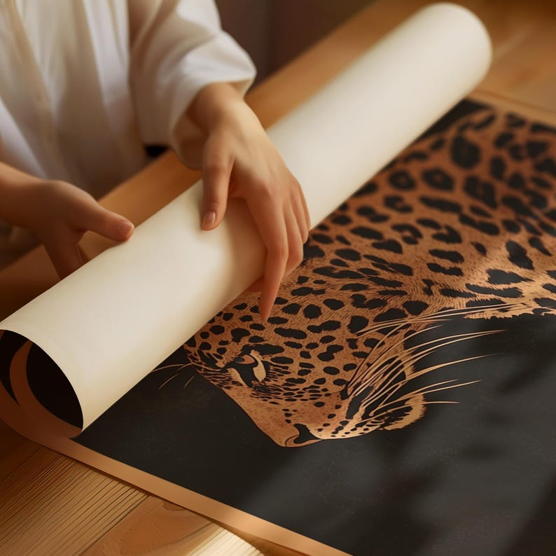 May include: A close-up of a rolled-up poster featuring a detailed illustration of a leopard's face in gold and black on a black background.