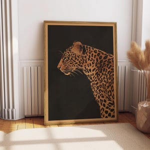 May include: A black and gold illustration of a leopard's head and shoulders against a dark background. The leopard's fur is detailed with black spots and stripes.