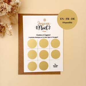 May include: A Christmas-themed scratch-off card with gold circles and the words "Joyeux Noël" in a decorative font. The card is on a brown envelope, with the text "Grattez et Gagnez!" and "3 symboles identiques sur la même ligne et c'est gagné!"