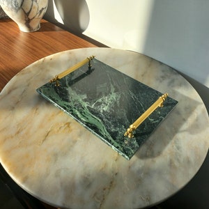 May include: A green marble serving tray with gold handles. The tray has a swirling green marble pattern.