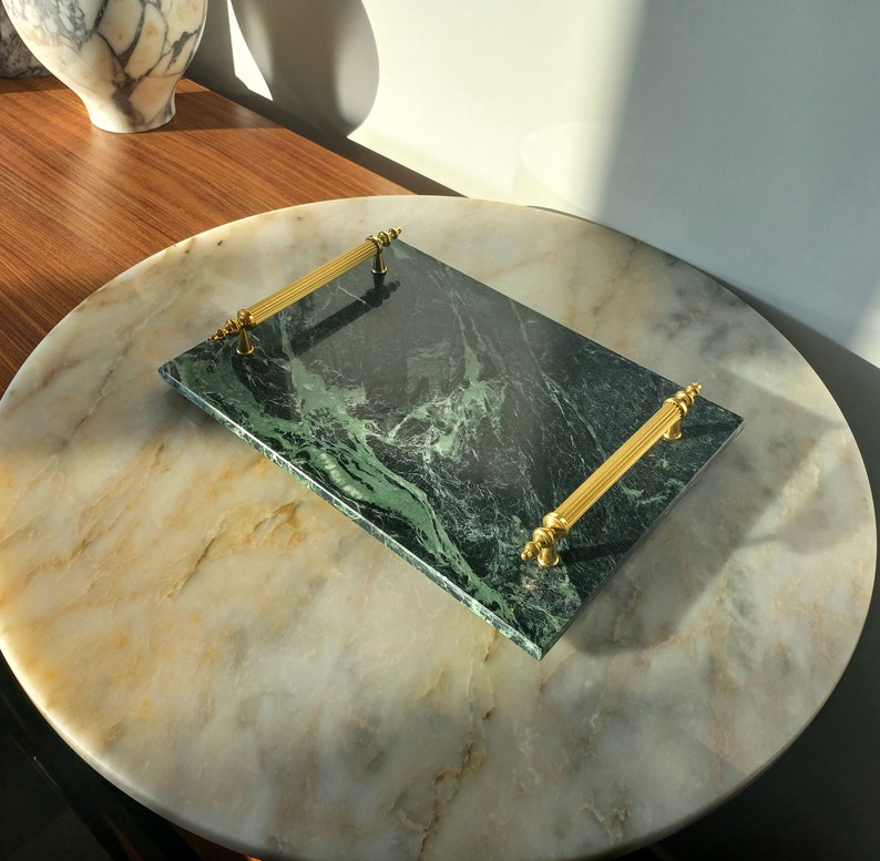 May include: A green marble serving tray with gold handles. The tray has a swirling green marble pattern.