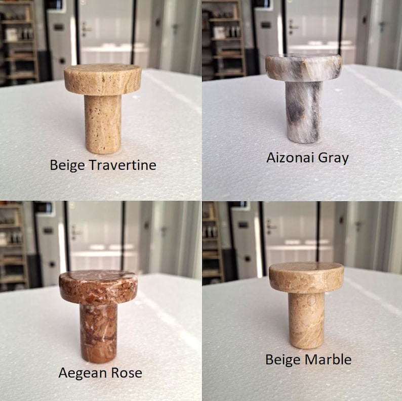 May include: Four stone bottle stoppers in beige travertine, Aizonai grey, Aegean rose, and beige marble. Each stopper has a cylindrical body and a round top. The names of the stones are printed below each stopper.