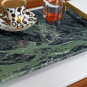 May include: A green marble serving tray with gold handles. The tray is rectangular and has a swirling pattern.