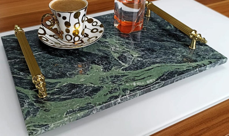 May include: A green marble serving tray with gold handles. The tray is rectangular and has a swirling pattern.