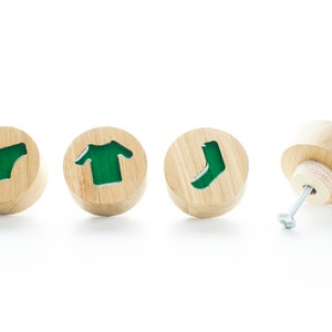 May include: Four wooden knobs with green resin inserts shaped like underwear, a t-shirt, a sock, and one knob with a screw.