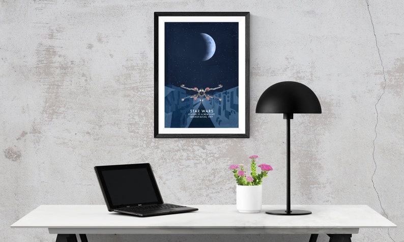 May include: A framed poster featuring a blue and white illustration of a spaceship flying through a city at night. The poster has the text "Star Wars" and "Journey to a Galaxy Far, Far Away" on it.