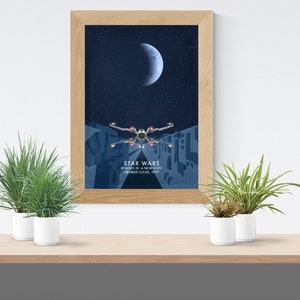May include: A framed poster with a blue background featuring a crescent moon and a starfighter flying through space. The poster has the text "Star Wars Episode IV: A New Hope George Lucas, 1977".