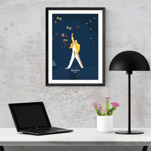 May include: A framed poster of a man in a yellow jacket and white pants, with a microphone in his hand, performing on stage. The poster has a blue background with white stars and the word "QUEEN" at the bottom.