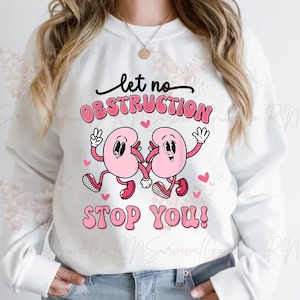 Puede incluir: Sudadera blanca con un gráfico rosa de dos riñones que se toman de la mano y el texto "let no obstruction stop you!"