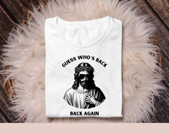 May include: A white t-shirt with a black and white illustration of Jesus wearing sunglasses and a crown of thorns. The text "GUESS WHO'S BACK BACK AGAIN" is printed on the shirt.