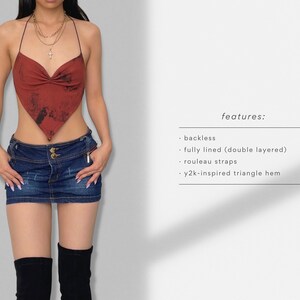 May include: A red halter top with a triangle hem and tie straps. The top is fully lined and features a tie-dye pattern. The text "features:" is written on the right side of the image, followed by a list of features: "backless", "fully lined (double layered)", "rouleau straps", and "y2k-inspired triangle hem".