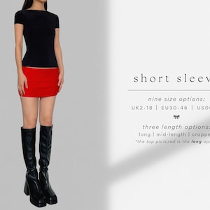 May include: A black short-sleeved shirt with a scoop neck and a red mini skirt. The shirt is pictured in the long length option. Nine size options are available: UK 2-18, EU 30-46, US 00-14. Three length options are available: long, mid-length, and cropped.