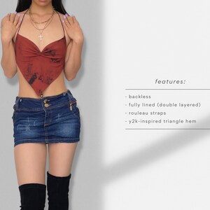 May include: A red and black tie-dye halter top with a triangle hem. The top is backless and features rouleau straps. The text "features:" is written in black on a white background below the image. The text below "features:" reads: "&bull; backless &bull; fully lined (double layered) &bull; rouleau straps &bull; y2k-inspired triangle hem"