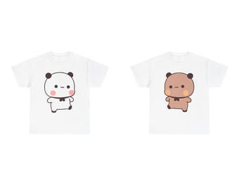 May include: Two white t-shirts with a cute cartoon panda and bear design. The panda is black and white with pink cheeks and a black bow tie. The bear is brown with pink cheeks and a black bow tie.