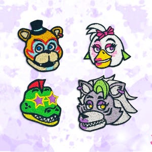 May include: Embroidered patches featuring four cartoon character faces. The characters include a bear with a top hat, a chicken with a pink bow, a green alligator with star-shaped glasses, and a wolf with green hair. The patches are colorful and detailed.
