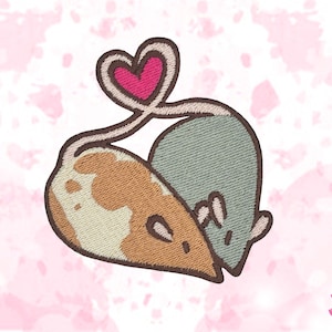 May include: Embroidered patch showing two cartoon mice, one tan and white, the other blue-grey, linked by a heart-shaped tail. The patch has a brown border and is set against a pink floral background.