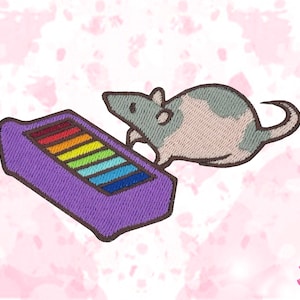 May include: Embroidered patch showing a cartoon rat with grey and white fur, next to a purple rectangle with a rainbow design. The patch has a stitched look, suitable for clothing or accessories.