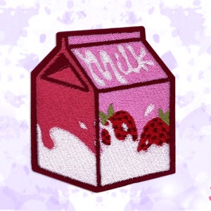 以下が含まれることがあります： ピンク色のいちごミルクパックのデザインの刺繍ワッペン。 パックは赤い上部があり、イチゴと白い文字で「Milk」が飾られています。 ワッペンは白い縁取りです。