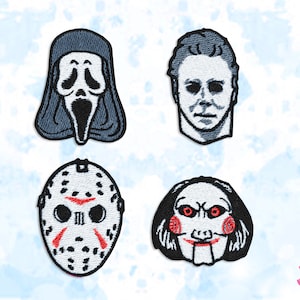 May include: Four embroidered patches depicting famous horror film characters: Ghostface, Michael Myers, Jason Voorhees, and Billy the Puppet. Each patch has detailed facial features and is outlined in black.