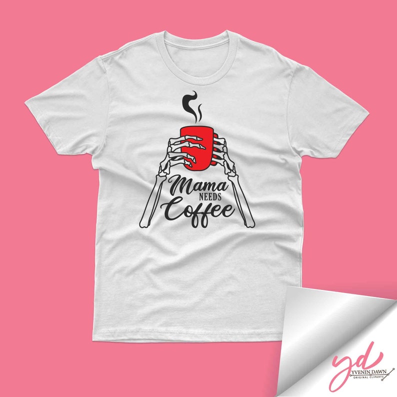 May include: White t-shirt with a black skeleton hand holding a red coffee mug. The text "Mama Needs Coffee" is printed on the shirt.