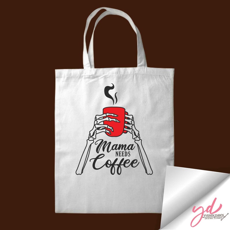 May include: White tote bag with a red coffee cup and skeletal hands holding the cup. The text "Mama Needs Coffee" is printed below the cup.