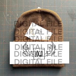 May include: A brown knit beanie with a white card tucked inside. The card has a black and white illustration of antlers and the text "DIGITAL FILE LOGO DIGITAL FILE".