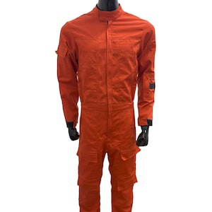 May include: A bright orange jumpsuit with black accents and multiple pockets. The jumpsuit has a zipper closure and a high collar.