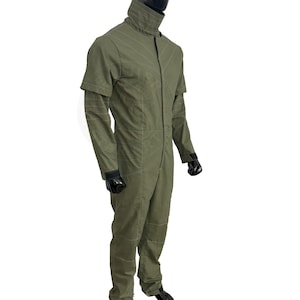 May include: A green jumpsuit with a zipper up the front and a high collar. The jumpsuit has a textured design and is made of a lightweight fabric.