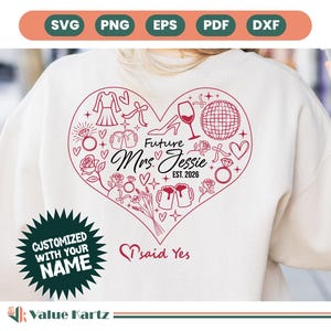 Puede incluir: Una sudadera blanca con un diseño rojo en forma de corazón. El diseño incluye un vestido, tacones altos, una copa de vino, una bola de discoteca y el texto "Future Mrs. Jessie EST. 2026." El texto adicional incluye "CUSTOMIZED WITH YOUR NAME" y "said Yes."