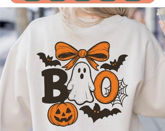 May include: Cream-colored sweatshirt with a Halloween-themed design. The design includes the word "BOO" with a ghost, pumpkin, bow, bats, and spiderweb. The top of the image has the words "SVG PNG EPS PDF DXF".