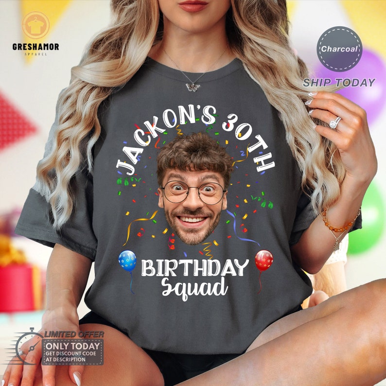 May include: A charcoal gray t-shirt with the text "JACKON'S 30TH" in white, a photo of a person's face, and the text "BIRTHDAY Squad" in white. The shirt is decorated with colorful confetti and balloons.