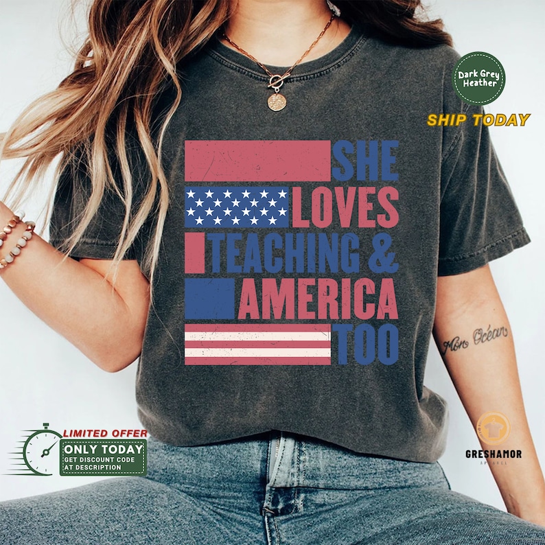May include: A dark grey heather t-shirt with a distressed American flag design and the text "SHE LOVES TEACHING & AMERICA TOO".