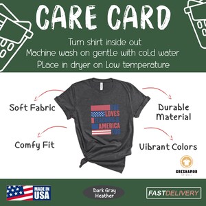 May include: Dark gray heather t-shirt with a red, white, and blue American flag design. The text "She Loves Teaching & America Too" is printed on the shirt. The shirt is shown on a white background with care instructions and product details.