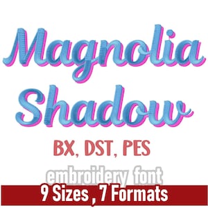 May include: An embroidery font design with the words "Magnolia Shadow" in a blue and pink 3D effect. The image includes size measurements from 2.5 cm to 8.9 cm and lists formats BX, DST, and PES. The design is for embroidery.