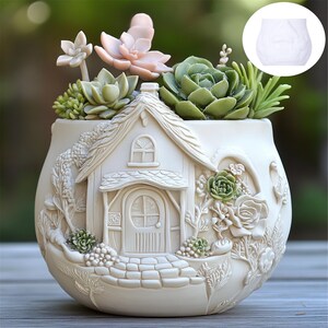 May include: A cream ceramic planter featuring a cottage design, filled with artificial succulents in green and pink hues. The round planter has a diameter of approximately 15 cm. Decorative garden pot.