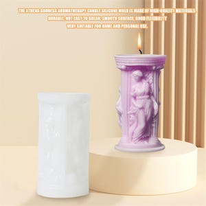 May include: White silicone mould for making a candle shaped like a column with a woman figure. The mould is on a light pink surface. The finished candle is shown in the background, with a lit candle on top.