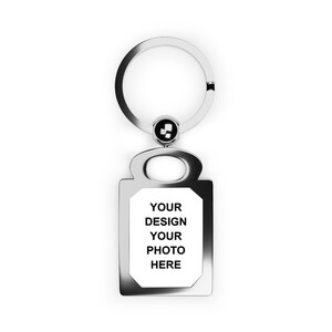 May include: Silver keychain with a rectangular tag that says "YOUR DESIGN YOUR PHOTO HERE".