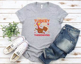 May include: A grey t-shirt with a graphic of a turkey running with the text "Run like a turkey on Thanksgiving".