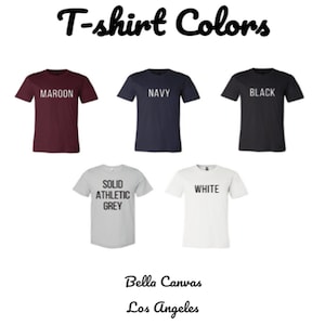 May include: An image displaying five t-shirts in various colors: maroon, navy, black, solid athletic grey, and white. Each shirt has the color name printed on it. The text "T-shirt Colors" is at the top, with "Bella Canvas Los Angeles" at the bottom.